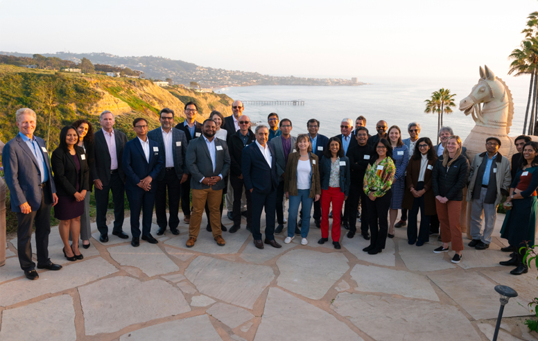 Gathering of people, standing on a terrace, with the ocean in the background, from the May 9, 2024 21st Century India Center event