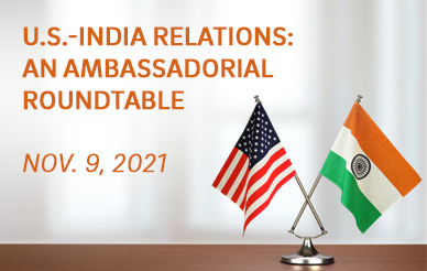 Flags of India and the U.S. sitting on a desk with orange text overlay, noting the roundtable event's name and date (Nov. 9, 2021)