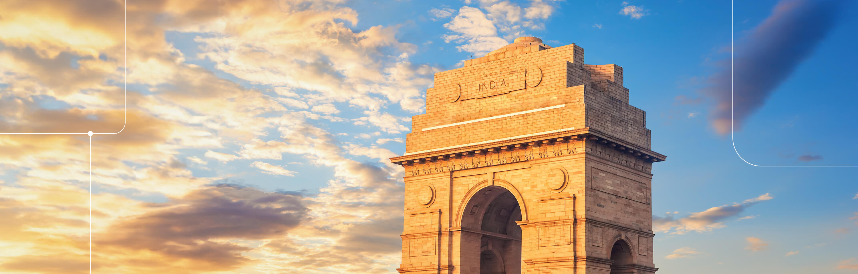 Gateway of India against a blue, sunset sky with clouds.